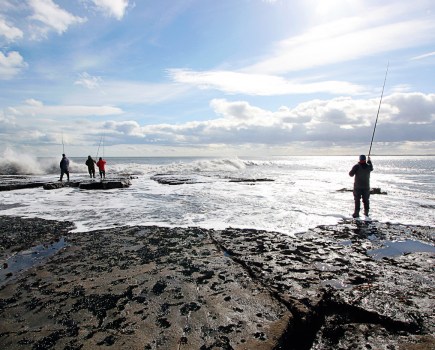 People fishing off rocks