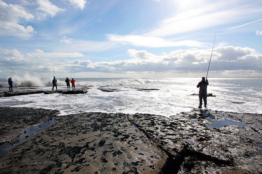 People fishing off rocks