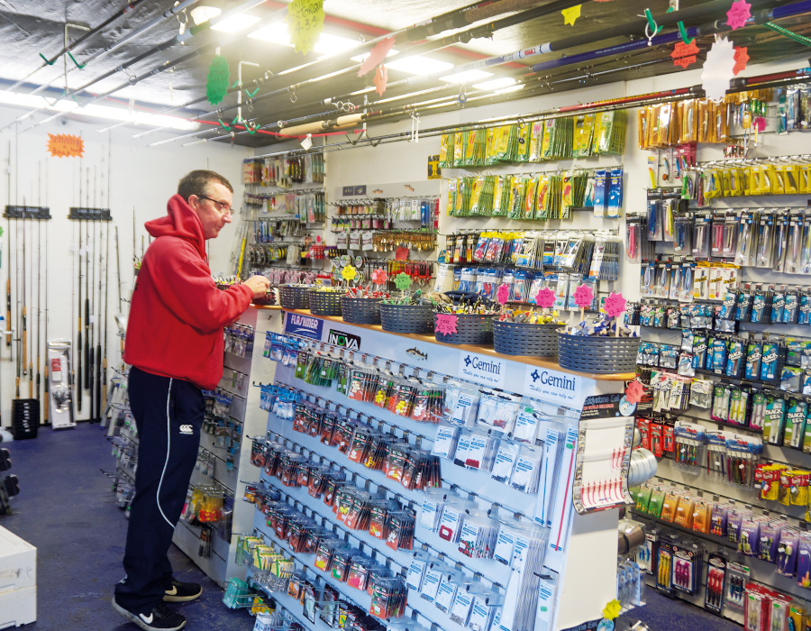 Man looking at shelves in tackle shop 
