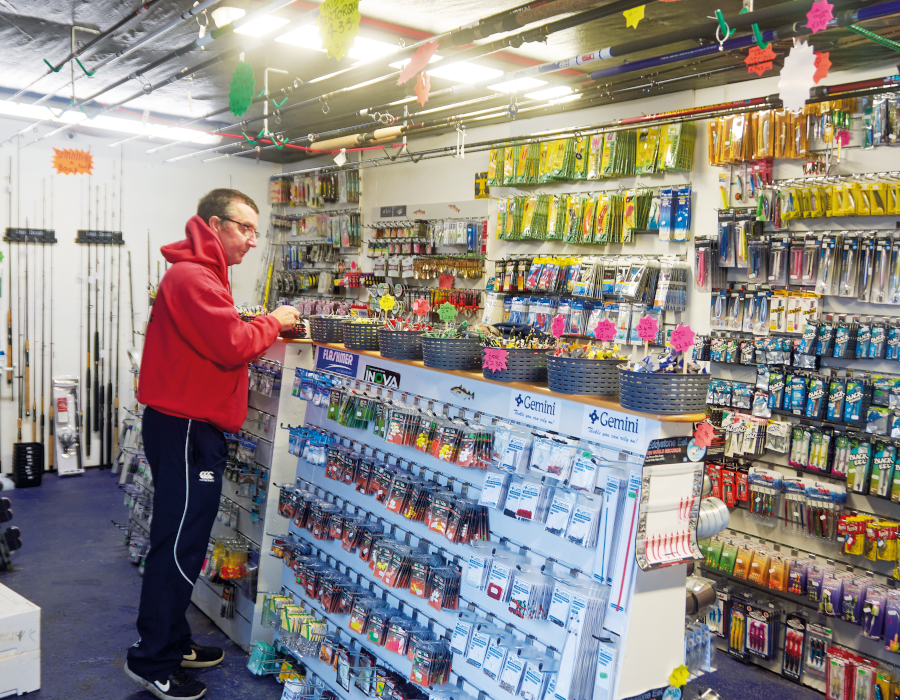 Man looking at shelves in tackle shop