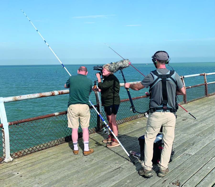 Film crew looking at an angler tackling up