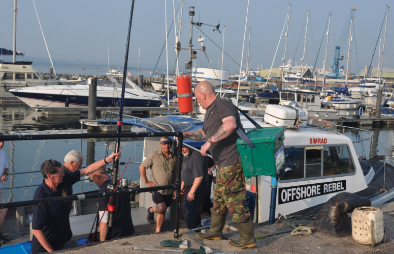 People gathering at a fishing boat 