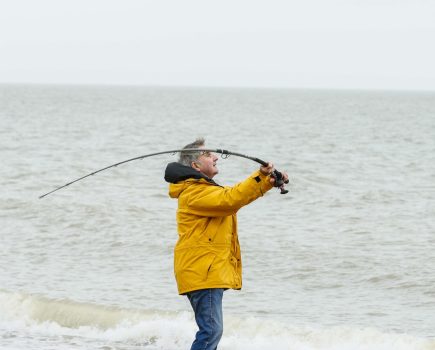 Man casting Fireblade on beach