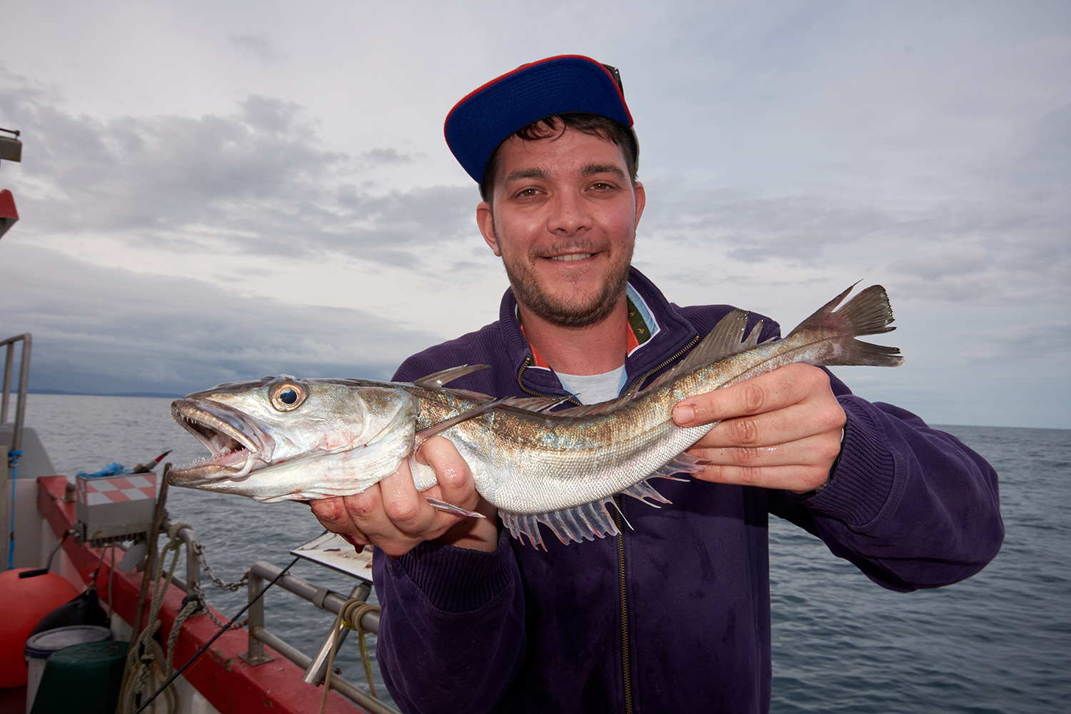 Man holding a deep water hake