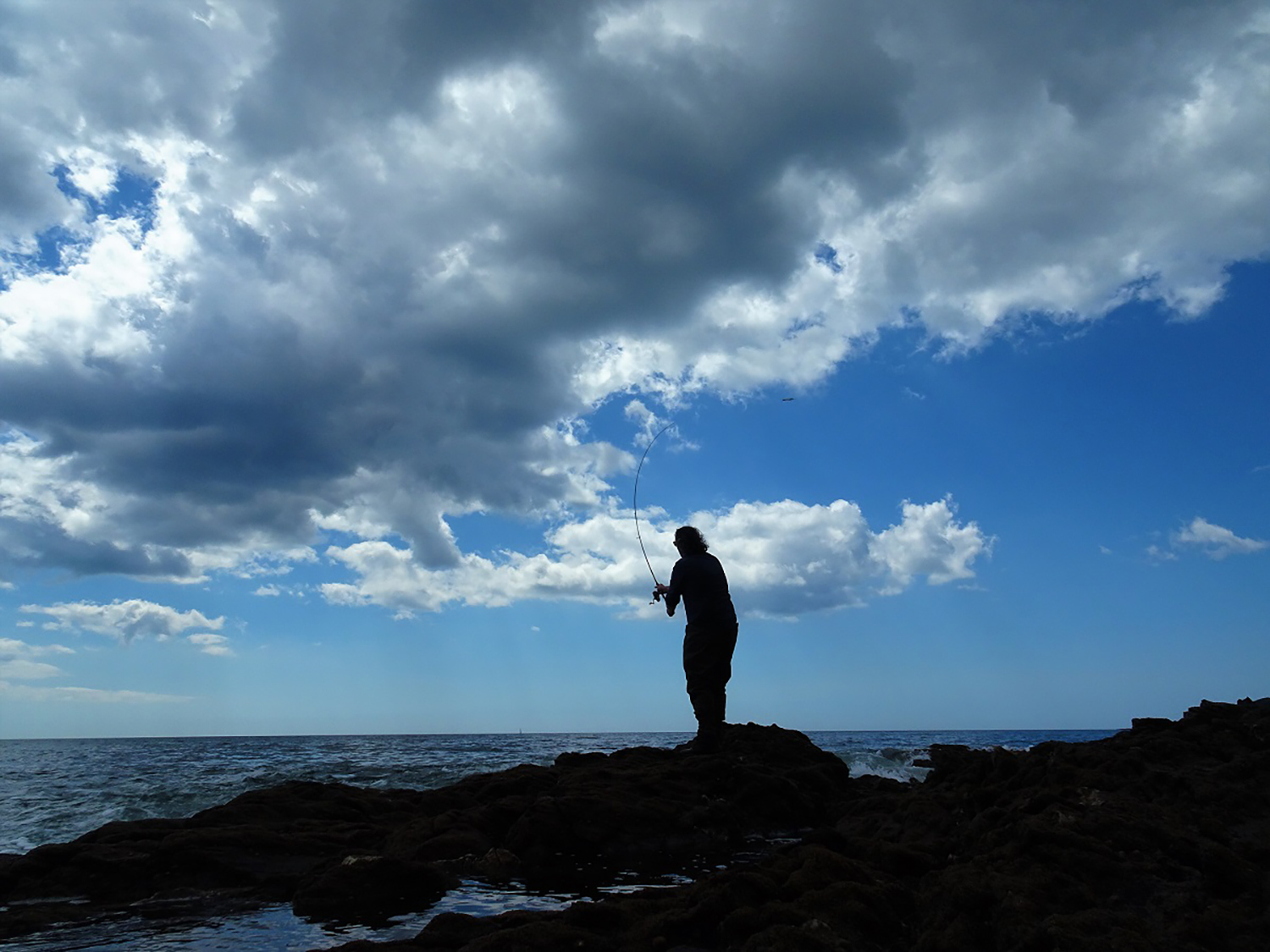 man fishing on beach