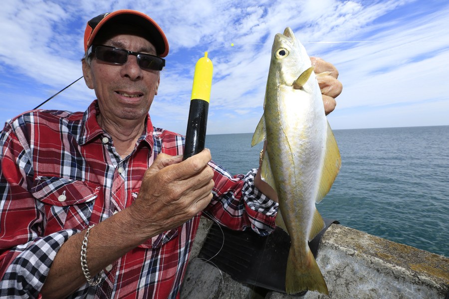Man holding fish caught with sliding float