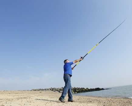 Man casting on beach