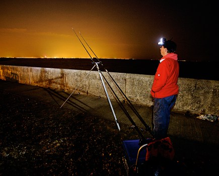 man fishing in autumn at night